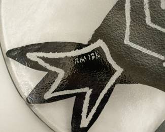 Closeup of the two pieces of hand-painted art glass tableware (platters or plates) from Kosta Boda, designed by Swedish artist Ulrica Hydman-Vallien. Part of the "Kaboka" or "Caramba" series, known for its bold, hand-painted black details and fish motifs. 