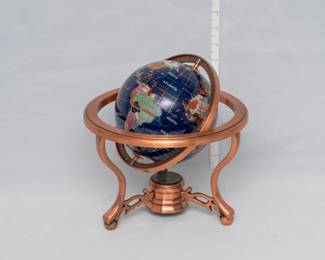 A handcrafted gemstone stone world globe with lapis ocean, on a copper-plated stand
