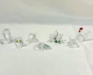Swarovski crystal figurines including Swarovski crystal cobra snake figurine designed by Heinz Tabertshofer, a Swarovski cystal miniature owl figurine, Swarovski crystal snail on vine leaf, a mouse figurine, a Swarovski crystal 2013 Renewal Membership Orchid figurine in clear crystal with a green crystal stem, a Swarovski crystal elephant, and a Swarovski Rooster crystal figurine