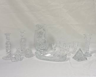 Beautifully sparkling crystal including a pair of Waterford Crystal candlestick holders, a Hoya Japan crystal River Canyon vase, a set of four signed Steuben glass cordial glasses, a Waterford Crystal pyramid paperweight, and more!