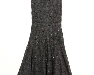 A swingy 1960s vintage black raffia crochet sleeveless dress in fit-and-flare style, embellished with rhinestones