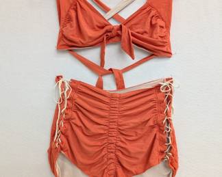 Classic vintage 1940s era bathing suit from Cole of California! The "Swoon Suit" with high waisted ruched and side-tied bottoms and an adjustable halter neck top, was launched in 1943 by head designer Margit Felligi — a trailblazer in the swimwear industry, credited with several innovations and holding multiple government patents throughout her career. The Cole Swoon Suit was shown in a May 1944 advertisement in Harper's Bazaar, and a version of this Cole Swoon Suit resides in the The Metropolitan Museum of Art in New York. "During World War II the company made parachutes, resuming full swimwear production after the end of the war. However, Fellegi continued to work on a limited number of designs, including the 1943 Swoon Suit, a two-piece suit that used side-laces to compensate for the lack of rubber."