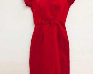 A vintage cherry red velvet dress with short sleeves and velvet bows at the waist
