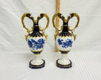 A pair of Royal Dux Bohemian porcelain ewers/vases  displaying an Art Nouveau style with the baroque twin handles, a sculpted pedestal, and a classic amphora shape