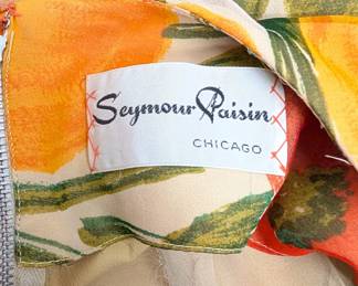 Closeup of the vintage 50's/60's Seymour Paisin floral tulips print sleeveless dress with velvet tied bow belt, a classic "fit and flare" silhouette from the beloved family-owned boutique Seymour Paisin Ladies Apparel in Chicago (1950 to the early 1980s.)