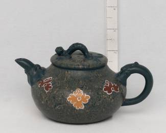 A vintage Yixing Zisha small teapot with lizard finial and flowers painted on the marbled clay body. Hand crafted in China.