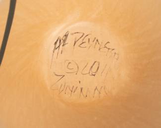 Closeup of the Native American Zuni Pueblo four-lizard seed pot, beautiful pottery created by artists Avelia and Anderson Peynetsa; signed and dated 2011 on base. This handcrafted pot is made from terracotta clay decorated with mineral pigments and features four lizards wrapped around the body of the pot, with their heads extending above the top.