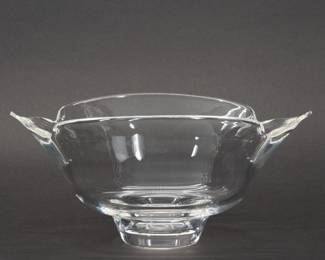 Steuben Glass Calyx Bowl designed by Donald Pollard. Originally designed for Steuben in 1962 by Donald Pollard, this graceful flaring Calyx Bowl No. 8115 features an unusual contemporary design. Nature supplied inspiration to the artisan of this fluidly rendered piece, as it takes its animated form from the calyx of a flower – the tender cup from which petals emerge. Quatrefoil shape and elevated on a round base, with etched Steuben signature. Size 10-1/2 inches L x 7-1/2 inches W x 3-1/2 inches H.