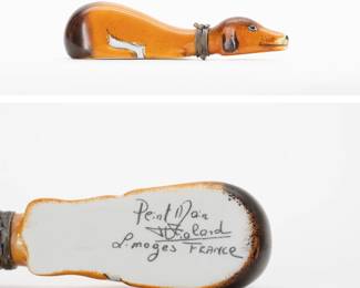 A charming vintage Limoges box in the form of a tan/white/black dog lying down, the collar serving as the clasp. Marked in script on the base with Peint Main (Hand Painted) Limoges France.