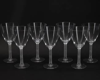Seven signed Lalique Phalsbourg pattern water goblets, 7 1/4 inches H. Each squared, frosted stem is molded with grape vines. Each sparkling glass is etched on the underside of the foot with Lalique France in script. Originally designed under Rene Lalique in 1924, this pattern was made 1924 - 2021.
