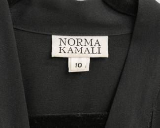 Closeup of the classic Norma Kamali "Geralyn" short sleeve black jumpsuit, semi-sheer striped front and wide-leg silhouette; size 10