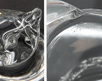More views of the rare signed Steuben Glass fox figurine from a 1989 design by Lloyd Atkins. This Steuben glass fox model No. 8582 has its pointed nose and ears tilted upward—perhaps as it looks at birds in the sky—while its voluminous tail is wrapped around its side.  Artist initials L D A are next to the diamond point Steuben signature on the base. Size 3-3/4 inches L x 4-1/2 inches W x 6 inches H.