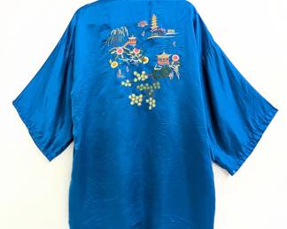 Another view of the vintage Chinese blue silk robe, hand-embroidered front and back with multicolor flowers, trees, pagodas and pavilions; Golden Dragon label.