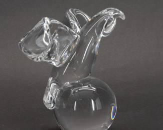 Another view of the large signed Steuben Glass classic eagle sculpture - Poised as if to take flight, this commanding Steuben eagle balances atop a solid glass globe. With fluid lines and seeming to emit light, this dramatic design No. 8130J is by James Houston and was introduced in 1964.  Size: 4-1/2 inches L x 12 inches W x 6 inches H.