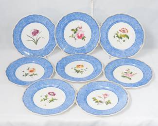 A set of 8 antique Chamberlain's Worcester porcelain plates with blue patterned borders encircling hand painted flowers, including fritillary, rose, pansy.