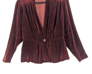 A coppery dark red velvet blazer, with ruched shoulders and single button front closure