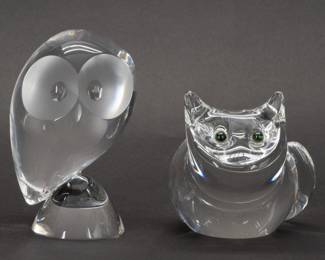 A signed Steuben Glass owl figurine No. 8065 and signed Steuben Glass Smiling Cat figurine No. 8274 with its inset green tourmaline eyes. Both pieces show the mastery of stylized abstract expression from designer Don Pollard. For fans of “The Owl and the Pussycat" and classic high quality American art glass combined!