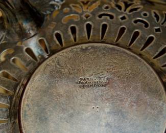 Closeup of one of the pair of antique silver plated chafing dishes by Garrard's London, each with a lid, liner, base and heating element insert. Marked Garrards Panton Street London on the base. Garrard's London was opened in 1735 on Panton Street by silversmith George Wickes; Robert Garrard became a partner in 1792 and eventually took sole control in 1802; and in 1843, Queen Victoria appointed Garrard as the Crown Jeweller. This pair of antique chafing dishes pre-dates 1911 when Garrard relocated their flagship store from Panton Street to Albemarle Street (where they are still in business today.)