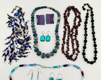 Beautiful beads and art glass jewelry - a double-strand blue, green and violet glass beaded necklace; a faceted black bead necklace, a graduated large bead necklace, possibly natural stone or coral; art glass beaded necklace with matching earrings, by Toba; a pair of Jan Wilcox handmade fused glass earrings, pair of bold checkered blue and pink pierced earrings, synthetic material; pair of DeVeer Designs hand made fused glass earrings, and a beautiful 26-inch necklace of rich deep red "pomegranate seed" glass beads