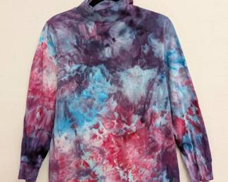 A tie-dyed mock neck long sleeve shirt