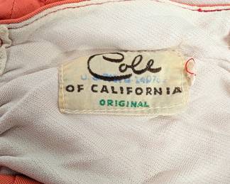 Closeup of the vintage 1940s era bathing suit from Cole of California! With high waisted ruched and side-tied bottoms, and an adjustable halter neck top. Called the "Swoon Suit" in a May 1944 advertisement in Harper's Bazaar, a similar model of bathing suit from Cole of California resides in the The Metropolitan Museum of Art in New York.