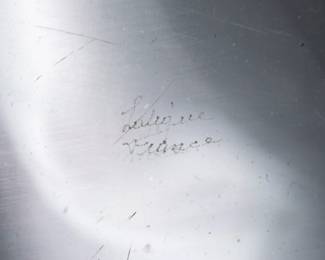 Closeup of the Lalique crystal decanter with a stopper and one tumbler or whisky glass, in the Femmes Antiques pattern originally designed by Marc Lalique in 1952. Clear and satin finish glass, molded with classical figures, and engraved signature Lalique France in script on the base. Decanter 9 1/2 inches tall, tumbler is 4 inches tall.