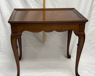 A Queen Anne style mahogany tea table, featuring a rectangular dish top, scalloped apron, cabriole legs, and pad feet