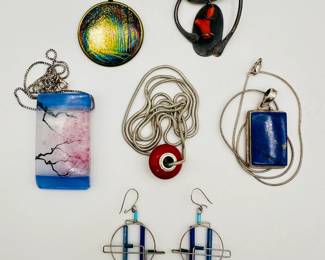 Beautiful modern style jewelry including a vintage sterling and coral pendant by New York artist Conrad Gersuny, a Barbie Levy Jewelry Design pair of handmade glass tube and wire earrings, a scenic pendant of fired resinated glass on stainless argentium silver plate bale by Julia Watkins; a lovely art glass rectangular pendant depicting flowering branches between sea and sky, signed by artist and on sterling silver box chain; a red enamel pendant by artist Barbara Minor, on sterling silver chain; and a rectangular polished blue stone pendant framed in silver and on sterling silver chain