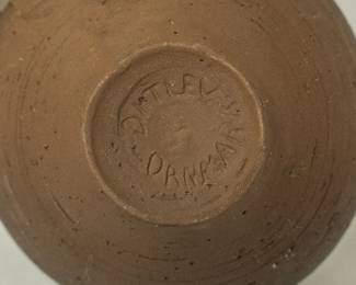 Closeup of signature on the Mid-century Modern pottery: a coffee pot, creamer and sugar bowl from Danish artist Henrik Ditlev Larsen.