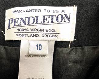 Closeup of the charcoal gray Pendleton wool skirt, knee length, with fringed hem, size 10