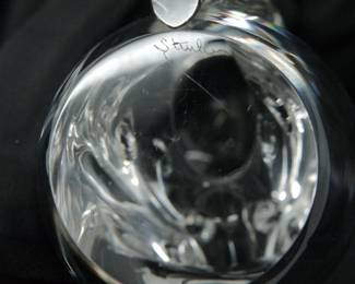 A closeup of signature on one of the two signed Steuben Glass squirrel figurines