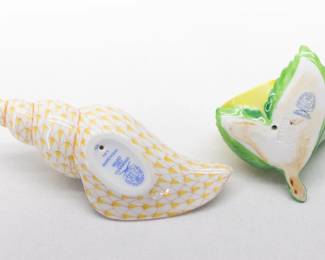 Another view of the Herend Tulip Shell in butterscotch fishnet pattern, and a Herend Lemon on Leaf menu or place card holder. Each with the Herend manufacturer marks to the base. Measurements: Shell 5 inches L x 2 1/2 inches W x 1 inches H, lemon 3 inches L x 2 1/2 inches W x 1 1/2 inches H.