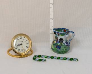 A 1970s vintage SLAVA soviet tabletop alarm clock, mechanical, made in USSR; an antique C. 1830-48 Mason's Ironstone pitcher or jug in Blue Willow design with additional colors, marked in black with Mason's Patent Ironstone China, England, with crown and swag banner; and a hand-blown glass candy cane.