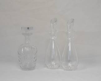 A vintage clear hand cut and etched crystal decanter, and a pair of mid-century modern signed Steuben Glass "teardrop" stoppered liqueur decanters, designed by Donald Pollard in 1953. See same decanter in the Corning Museum of Glass collection. 
