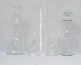 A cut glass decanter with stopper, two glass hand bells, and a Baccarat Crystal decanter with stopper