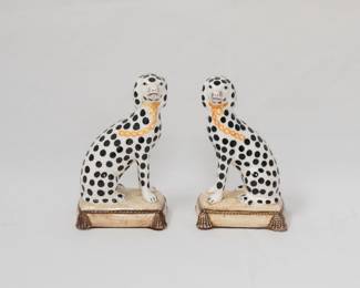 Pair of Staffordshire or Fitz and Floyd ceramic Dalmation dog figurines, modeled in mirror composition, each dog with a gold painted collar and leash, and seated on cushions.
