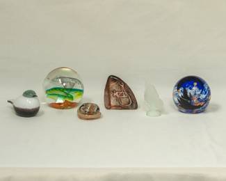 A selection of art glass paperweights and figurines, including a "Small Smew" glass bird from the Iittala Birds collection by Finnish designer Oiva Toikka, a vintage signed Mats Jonasson crystal "Cave Rock Carving" paperweight or sculpture from Målerås, Sweden; and a signed Sabino opalescent glass butterfly figurine