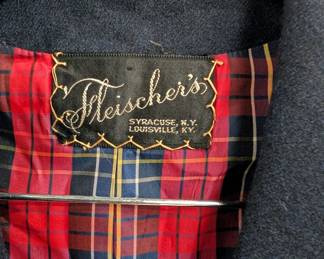 Closeup of a vintage Fleischer's charcoal gray skirt suit, with a fitted blazer and straight skirt