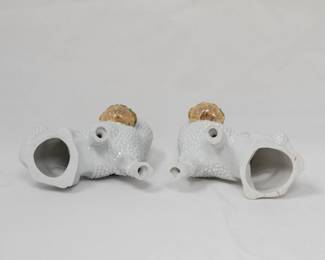 Another view of the vintage pair of ceramic poodle dog figurines, each holding the handle of a basket of flowers in its mouth; clear glaze and polychrome enamels. Possibly German made, late 19th/early 20th century