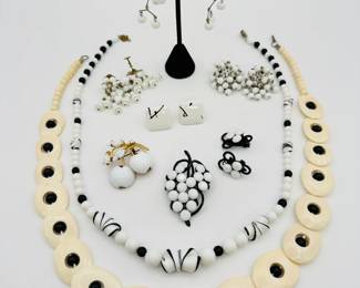 Fabulous black and white vintage costume jewelry including a 1960s milk glass grape cluster brooch and clip earrings, vintage Austria milk glass cherries and leafs brooch, set in gold tone metal, marked Austria on the back; milk glass bead mobile style dangle earrings, a 22-inch black and white art glass bead necklace, ceramic modernist style earrings, and more!