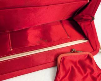 Another view of the vintage red and black lace evening clutch bag with kiss-lock clasps, the interior vivid red with interior pockets and a matching small coin purse