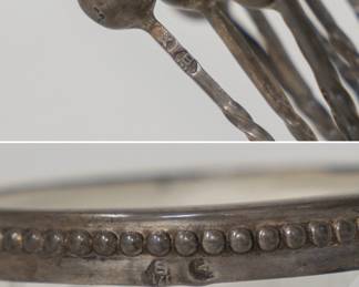 Closeup of the set of vintage silver cocktail or appetizer picks housed in a silver-rimmed cut-glass stand
