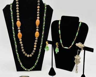 Asian-inspired vintage fashion jewelry necklaces, earrings, brackets and more including a silver tone brooch with dangling Asian lantern pendant, a Crown Trifari faux jade and gold tone link necklace and earrings set, a Chinese stone and carved Hediao bead necklace