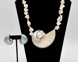 A vintage and gleaming chamber nautilus sea shell necklace, with large polished slice of chamber nautilus shell linked between small polished mother of pearl beads; along with a pair of small blue-tone polished iridescent nautilus shell earrings.
