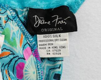 Closeup of vintage Diane Freis turquoise and floral pattern silk dress