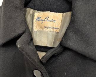 Closeup of vintage 1950s style black wool princess coat, inside tailor's label from Mary Benton, Norfolk Virginia