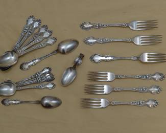 Antique sterling silver spoons and forks together with a baby spoon, hallmarked R. Wallace & Sons, in the "Violet" pattern, circa 1900. Monogrammed.