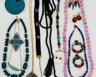 Vintage fashion jewelry including a midnight blue velvet choker with tiny seed pearl bow decoration, a pair of carnelian button clip earrings, colorful beaded necklaces and bracelets, a black bead lariat necklace, and pair of gold-filled turquoise, pink quartz and amethyst bead dangle earrings