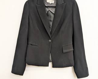 A Calvin Klein women's one-button black blazer with rhinestone skull and crossbones design on the back, size 4