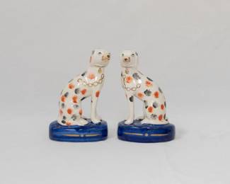 Pair of Staffordshire Dalmatian dog figures, modeled in mirrored positions and seated on cobalt bases. Hand painted polychrome enamels.